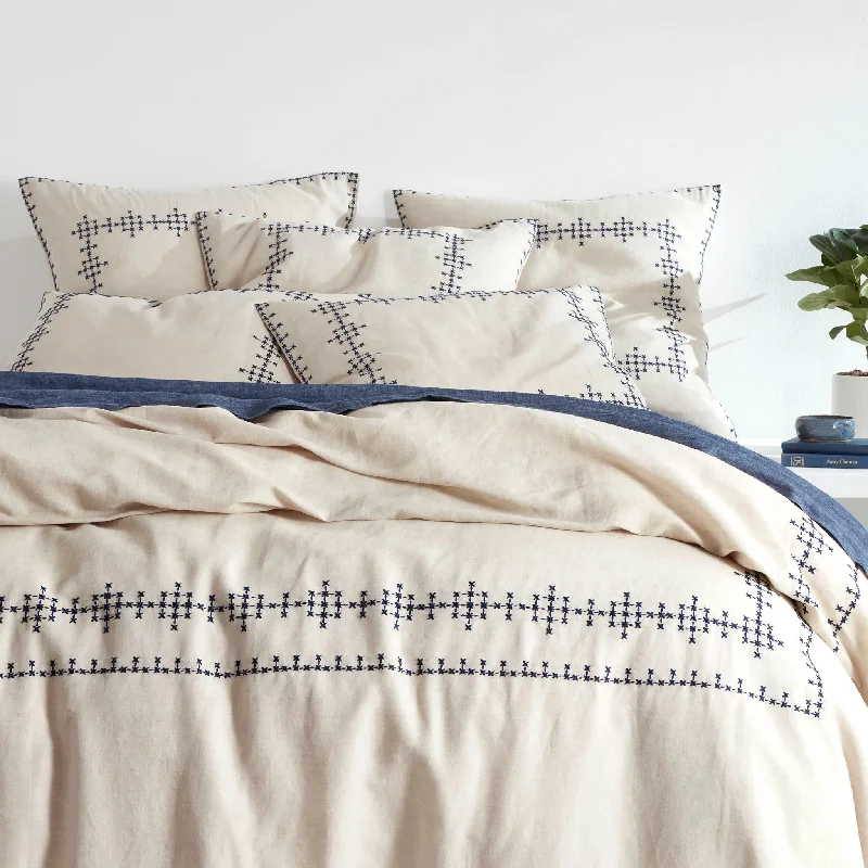 Patchwork duvet covers with a variety of fabric pieces sewn together for a rustic charmCross-Stitch Linen Navy Duvet Cover